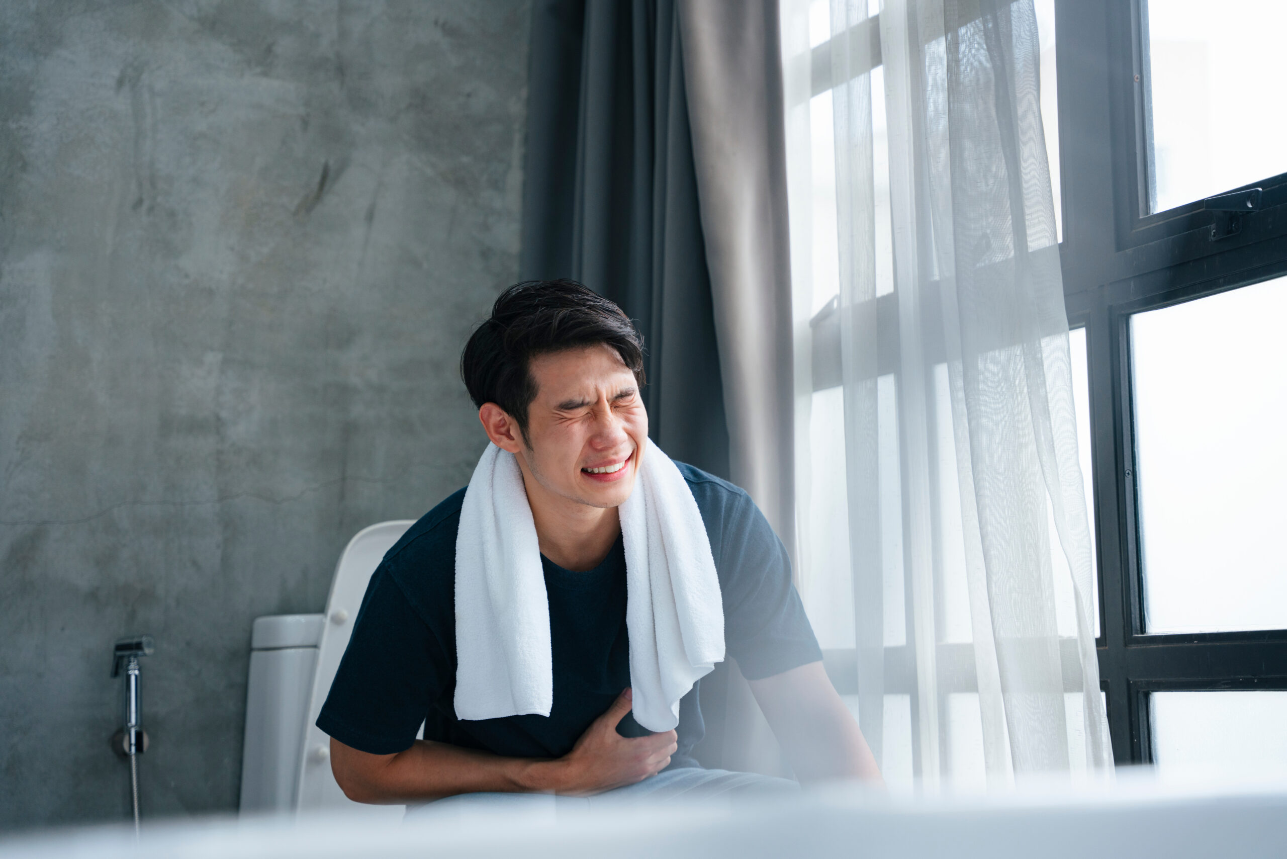 A man experiencing persistent constipation and diarrhoea.